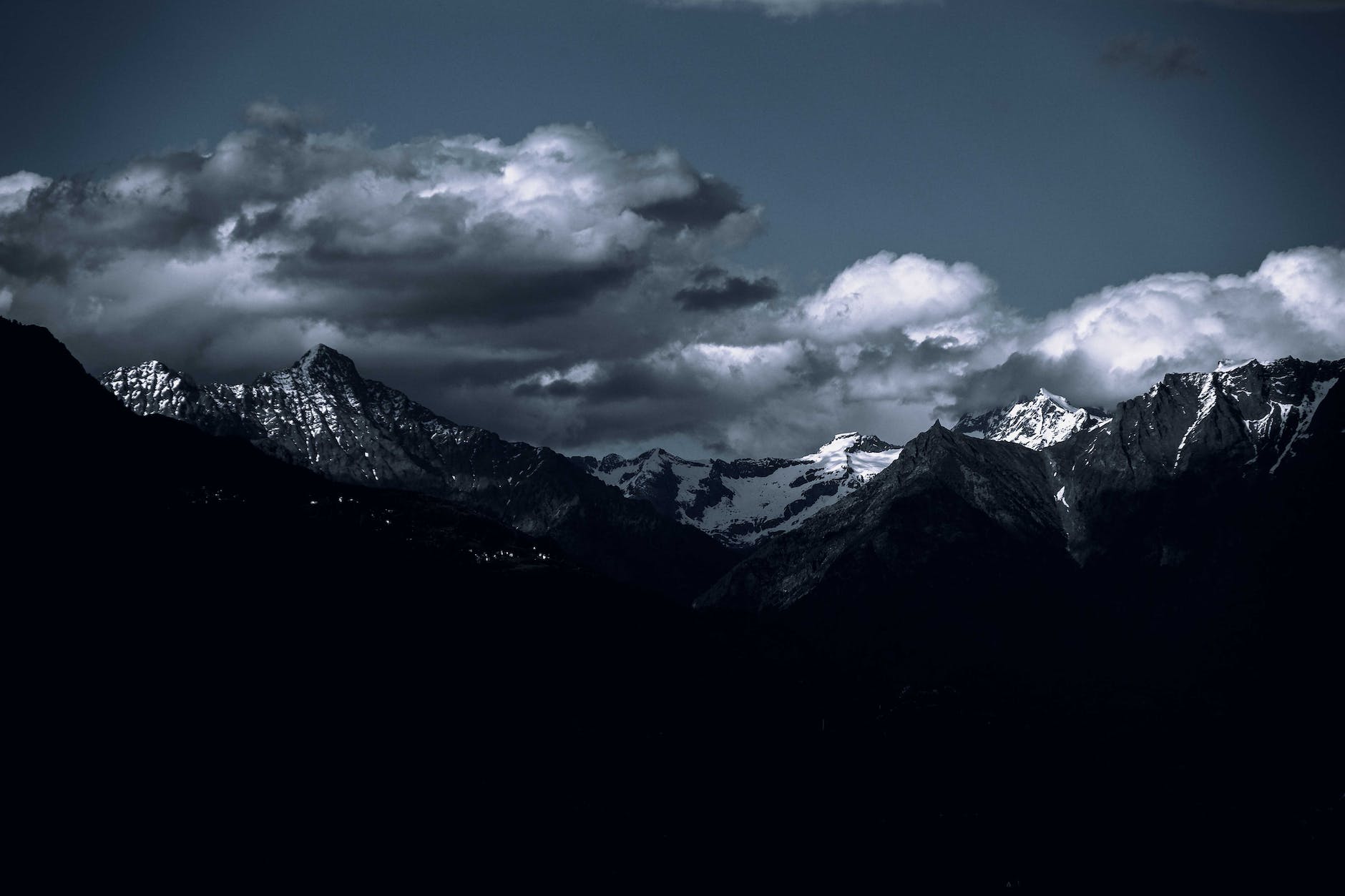 snowcapped mountains under a cloudy sky